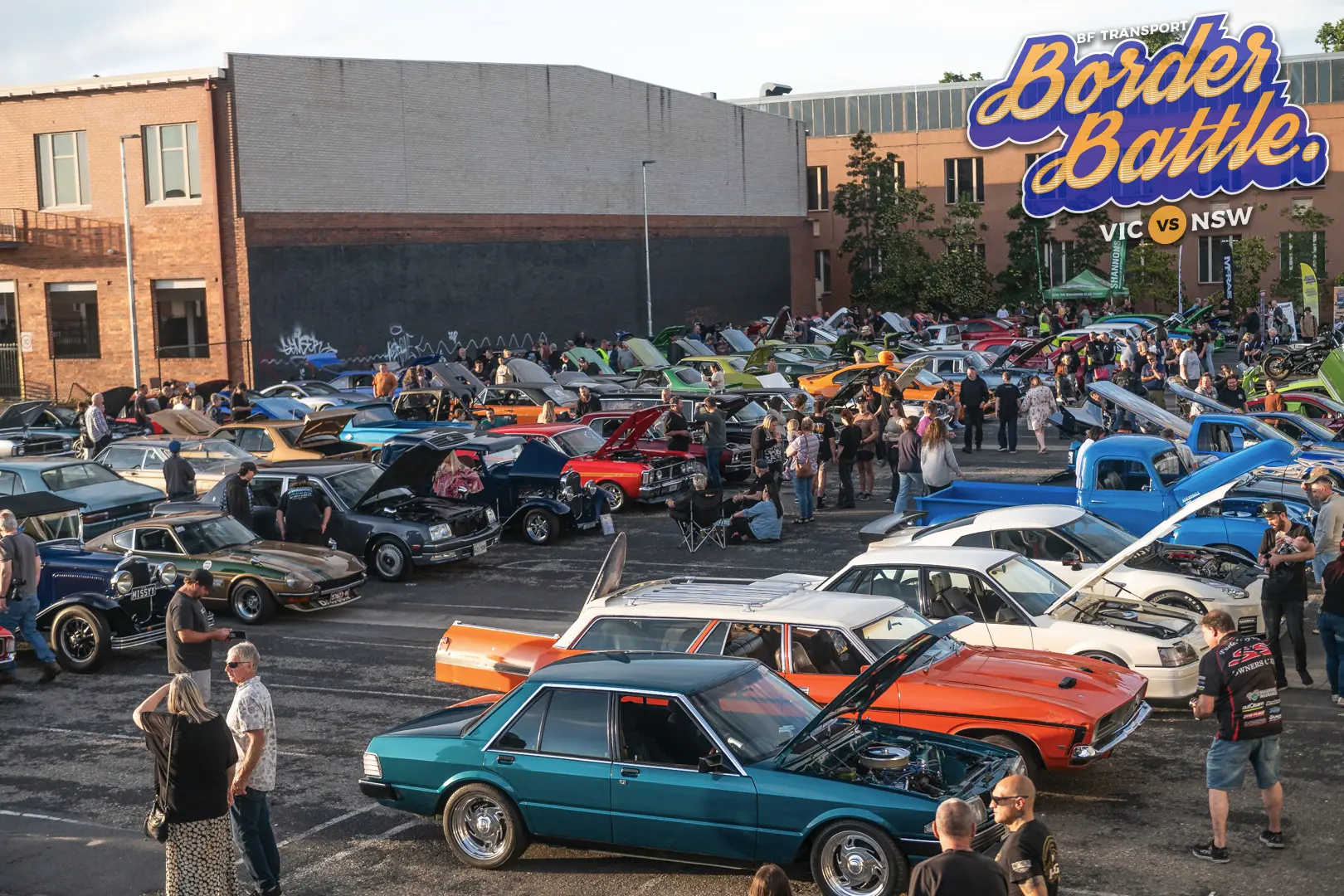 Large overview of the Border Battle car show filled with vehicles and spectators