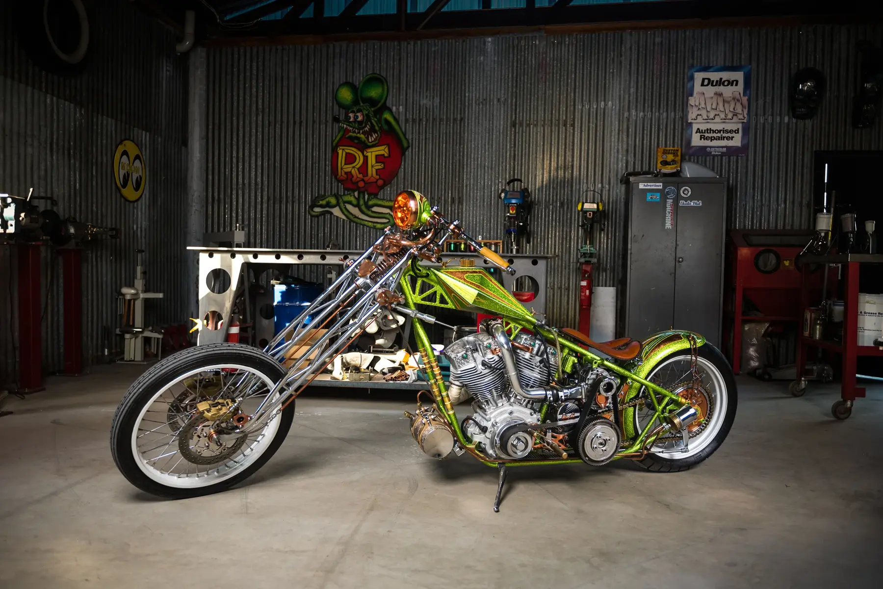 Custom motorcycle photographed inside an automotive workshop