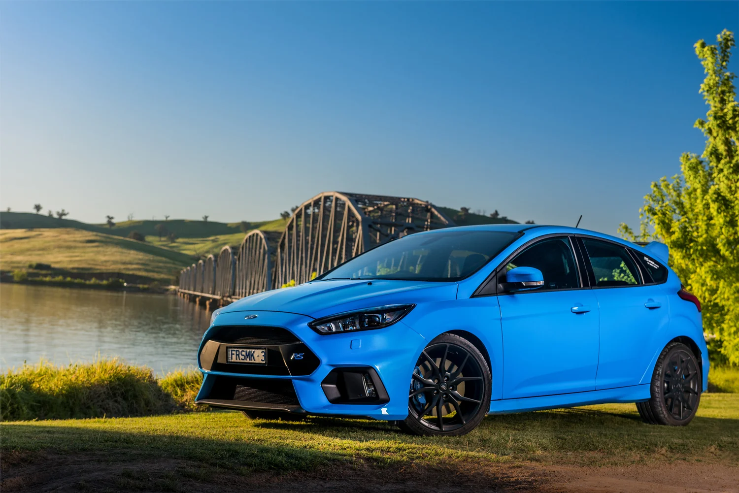 Blue Ford Focus RS photographed near a bridge